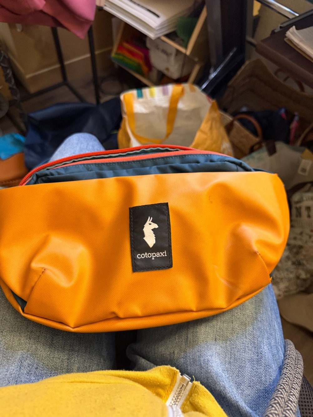 cotopaxi orange and teal waist pack
